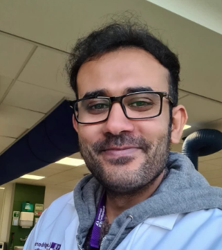 Muhammad Asad wears glasses and a Loughborough University labcoat